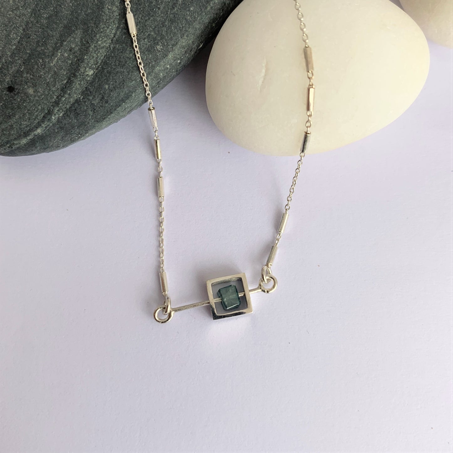 Solo Diamond Bead moving on a silver rod necklace