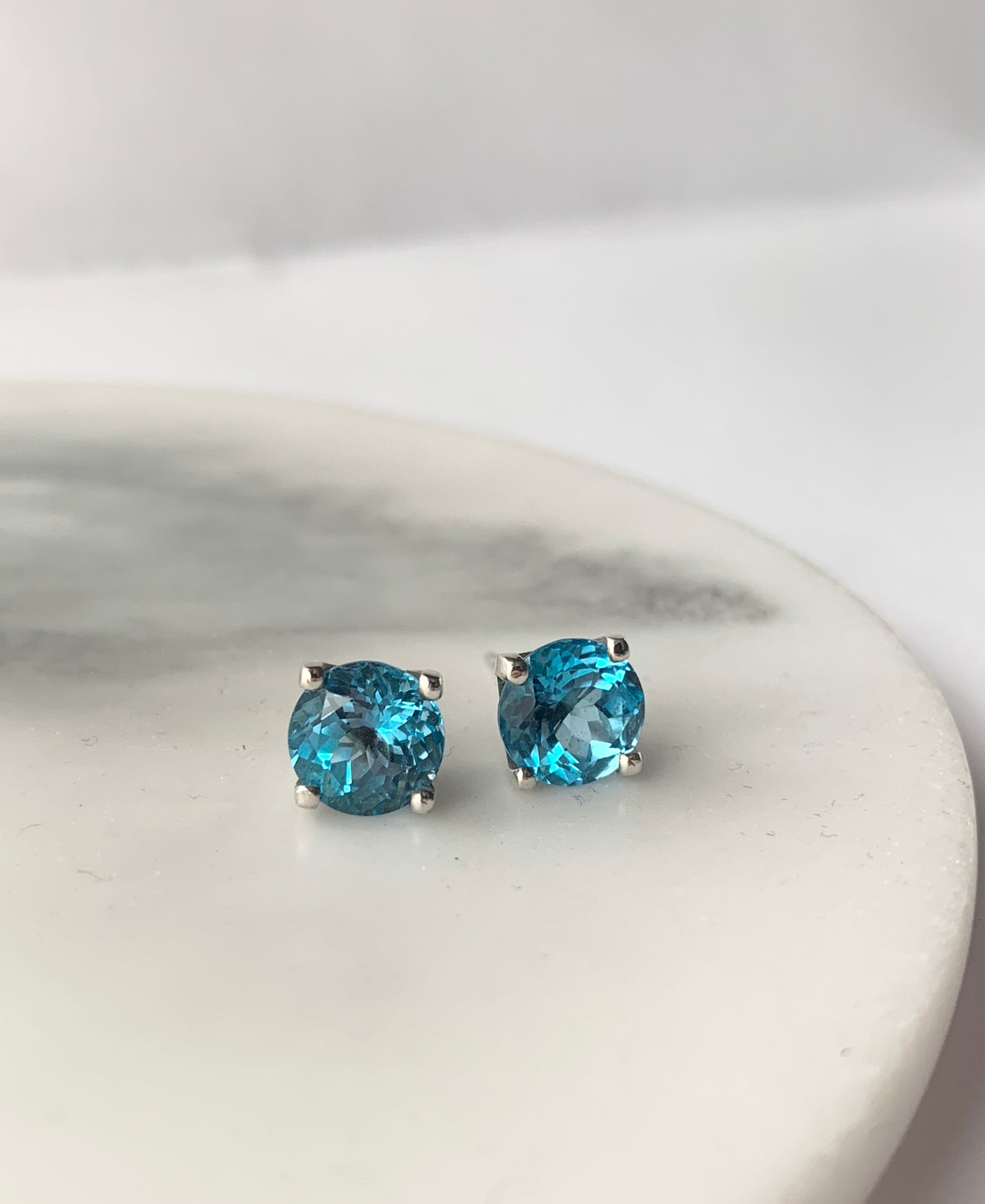 Swiss Blue Topaz stones set in square four claw earrings set in sterling silver