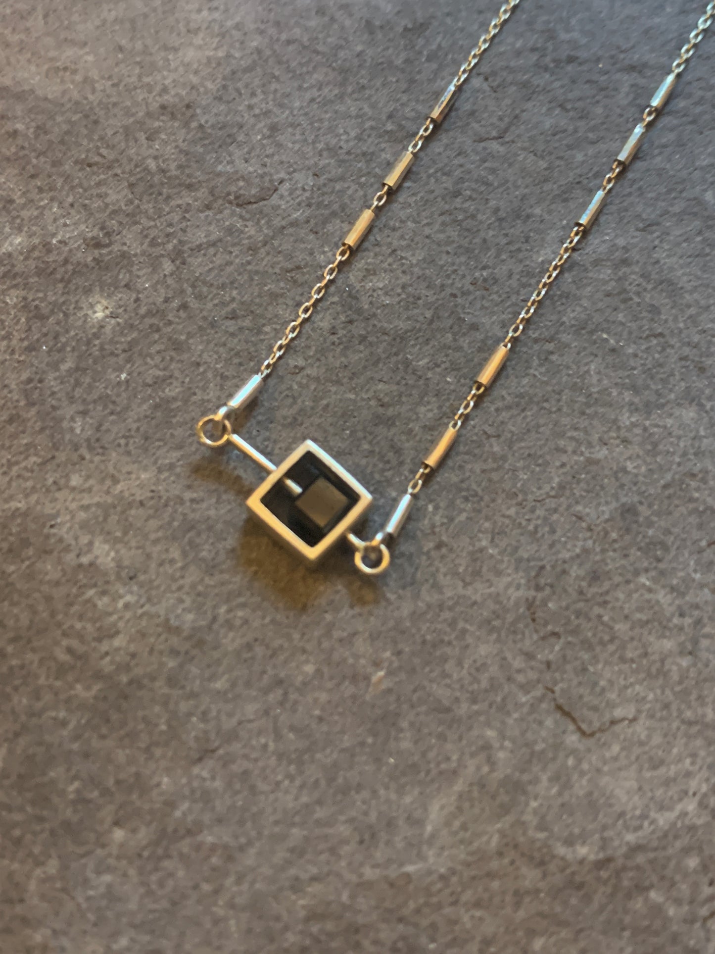 Solo Diamond Bead moving on a silver rod necklace