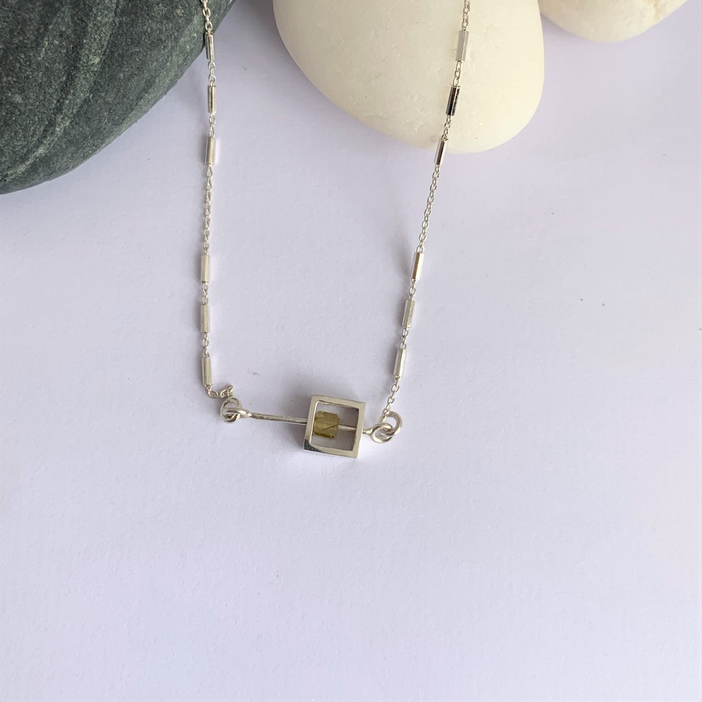 Solo Diamond Bead moving on a silver rod necklace