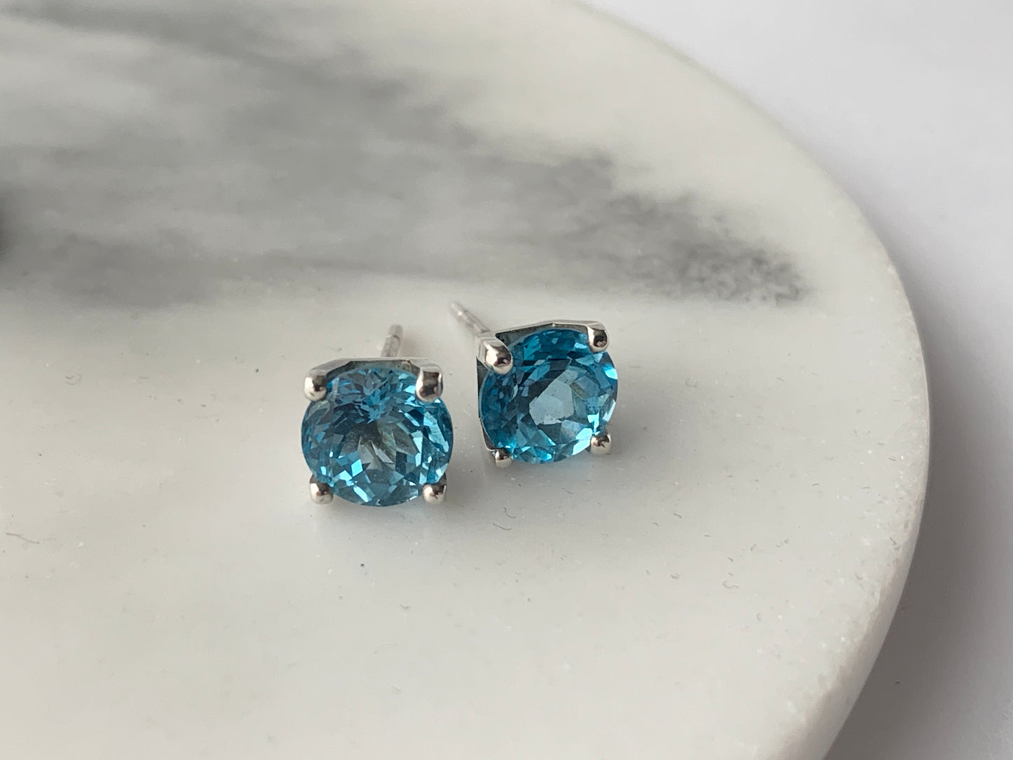 Swiss Blue Topaz stones set in square four claw earrings set in sterling silver