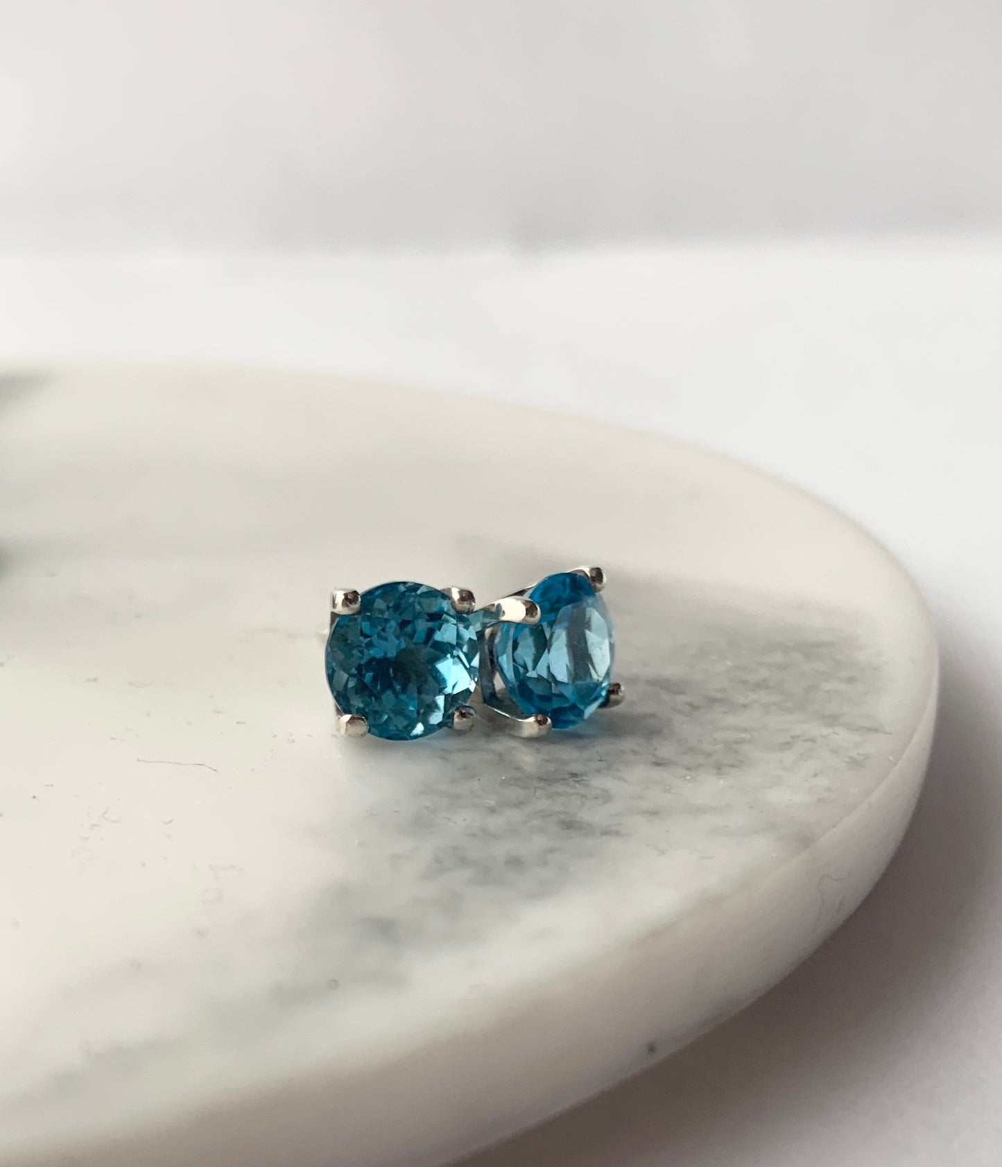Swiss Blue Topaz stones set in square four claw earrings set in sterling silver